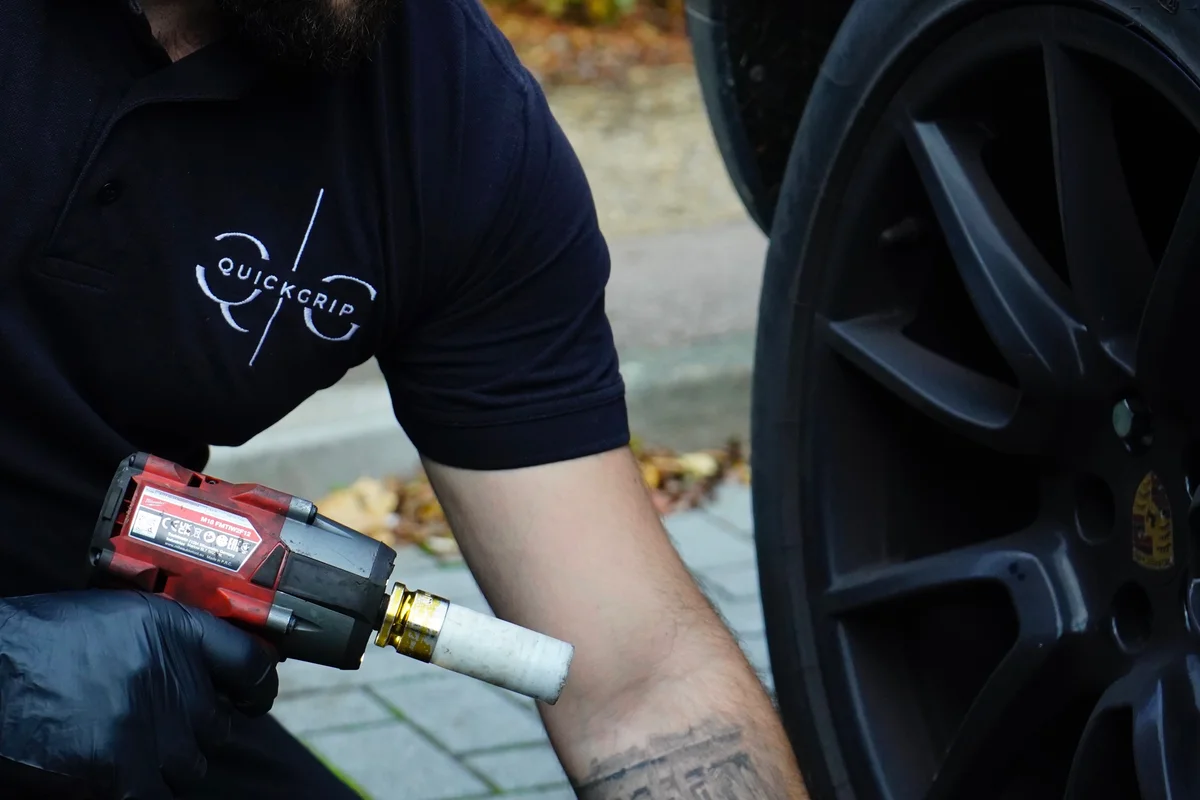 QuickGrip technician working precisely on a wheel