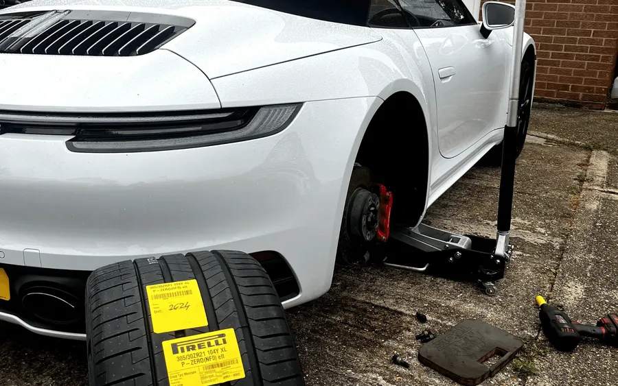 Porsche 911 jacked up with a Pirelli tyre and QuickGrip jack stand